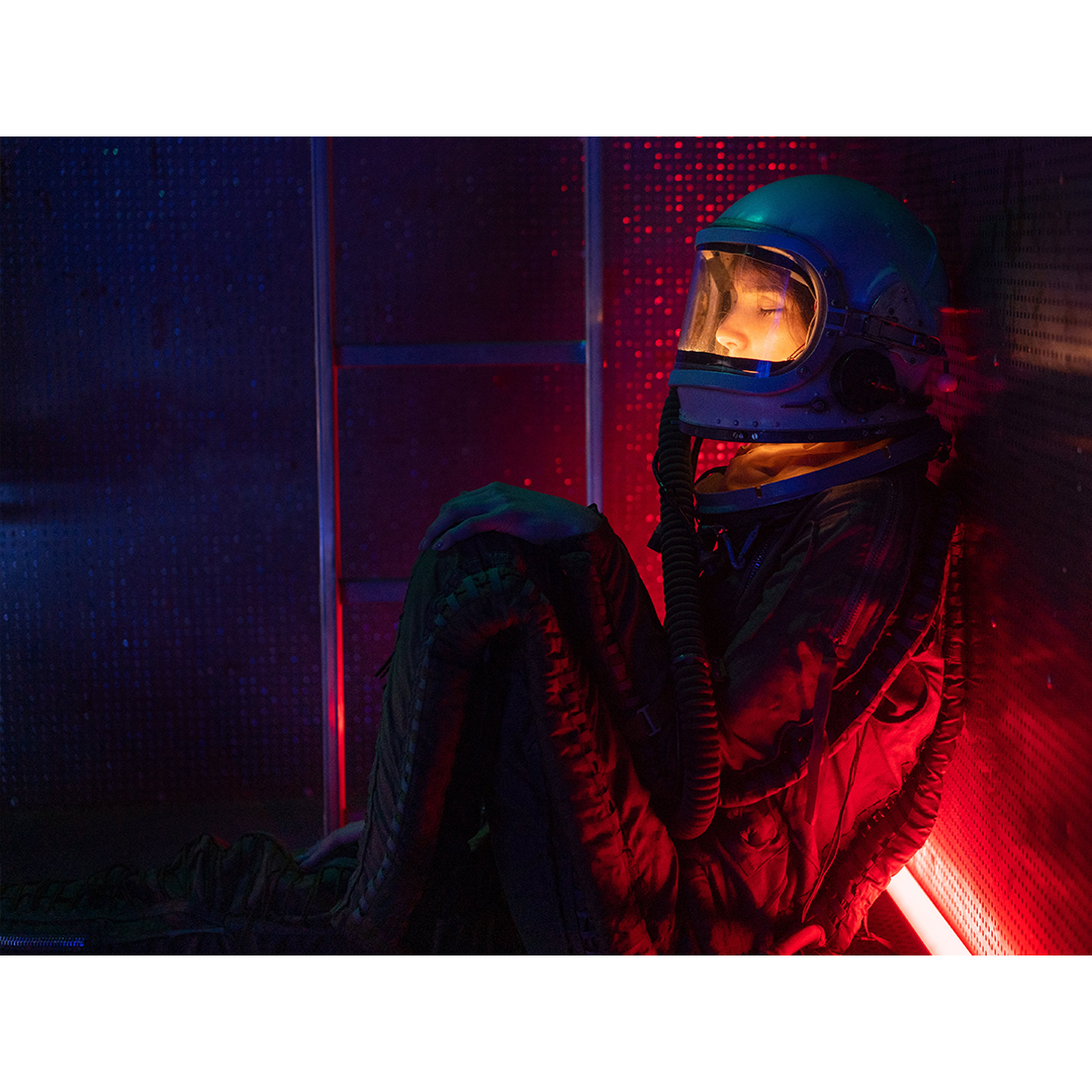 Photo by Mikhail Nilov from Pexels of a woman-in-space-suit-sitting-on-floor
